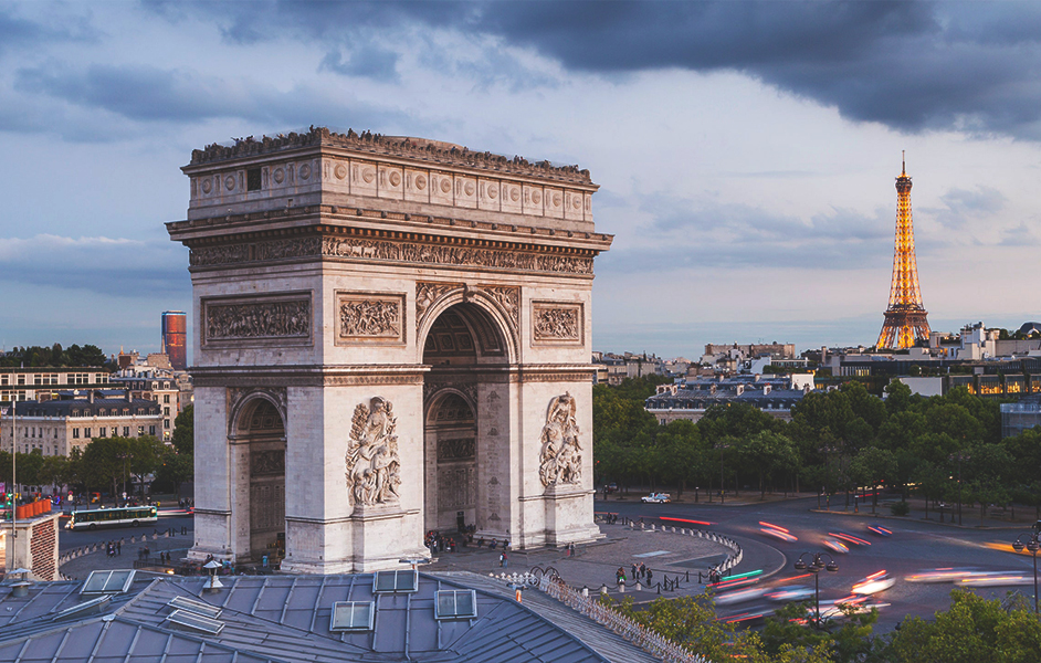 Paris Itinerary 4 days - The Arc de Triomphe standing tall at the end of the Champs-Élysées, with traffic circling the roundabout.