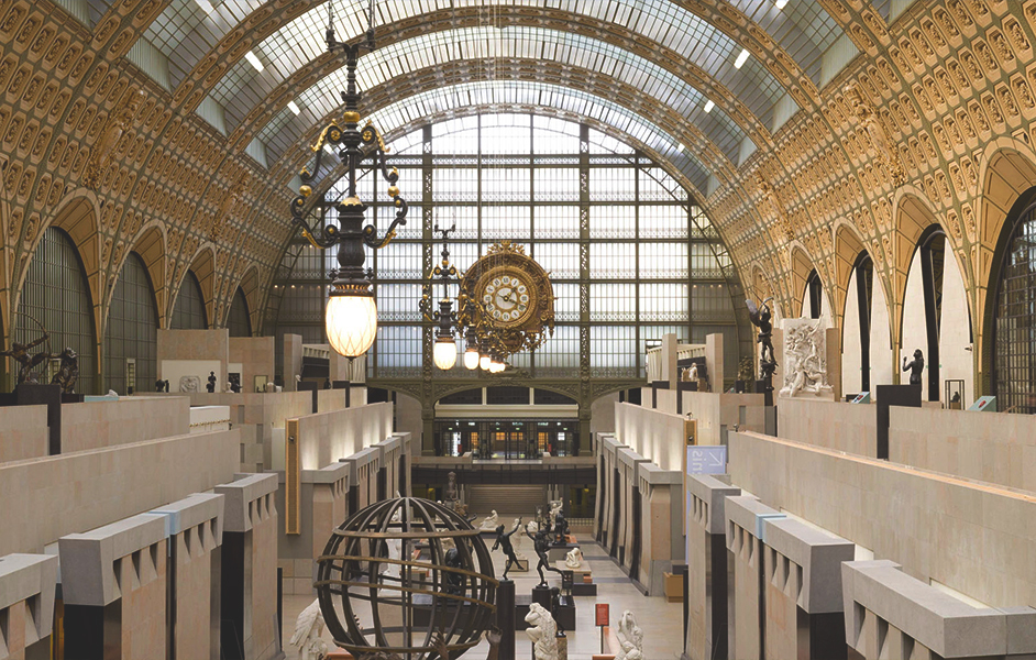 The grand hall of the Musée d'Orsay, housed in a former railway station, with its impressive clock and art exhibits.