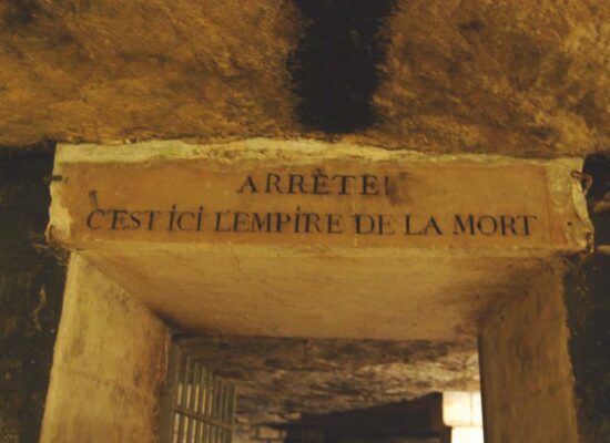 how big are the Paris Catacombs - Entrance to the Paris Catacombs with historic sign, hinting at the vast underground tunnels