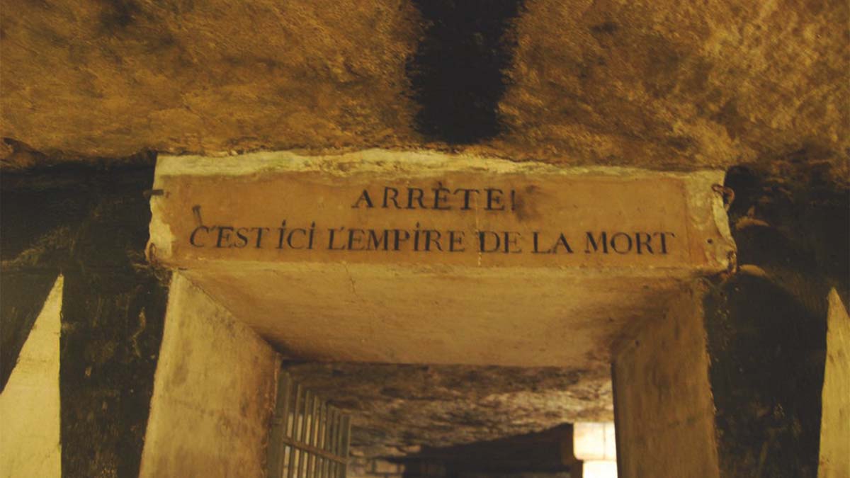 how big are the Paris Catacombs - Entrance to the Paris Catacombs with historic sign, hinting at the vast underground tunnels